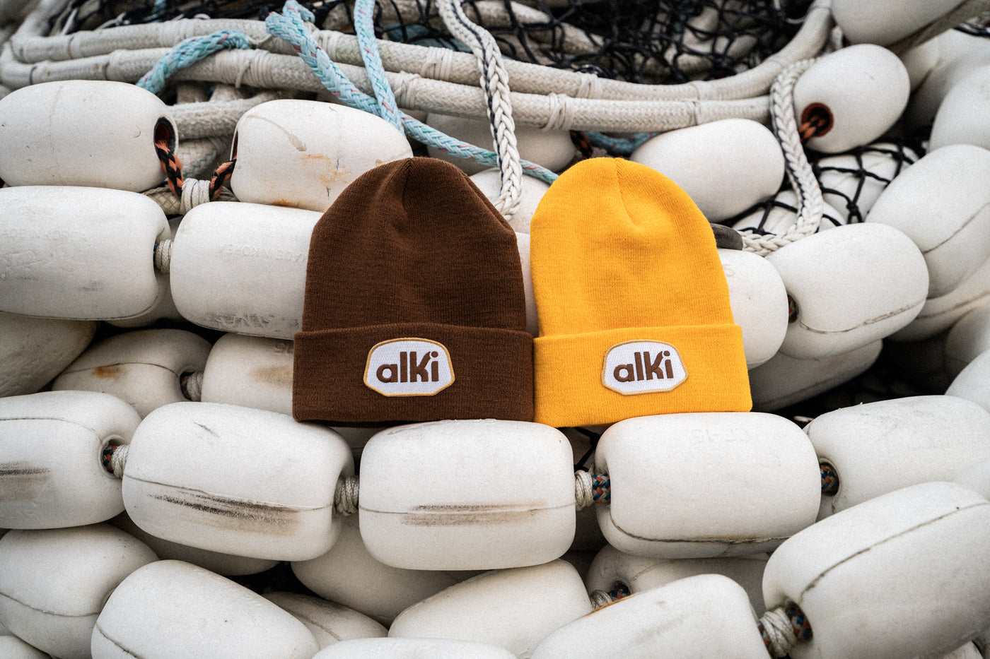 brown and yellow beanies with alki patches